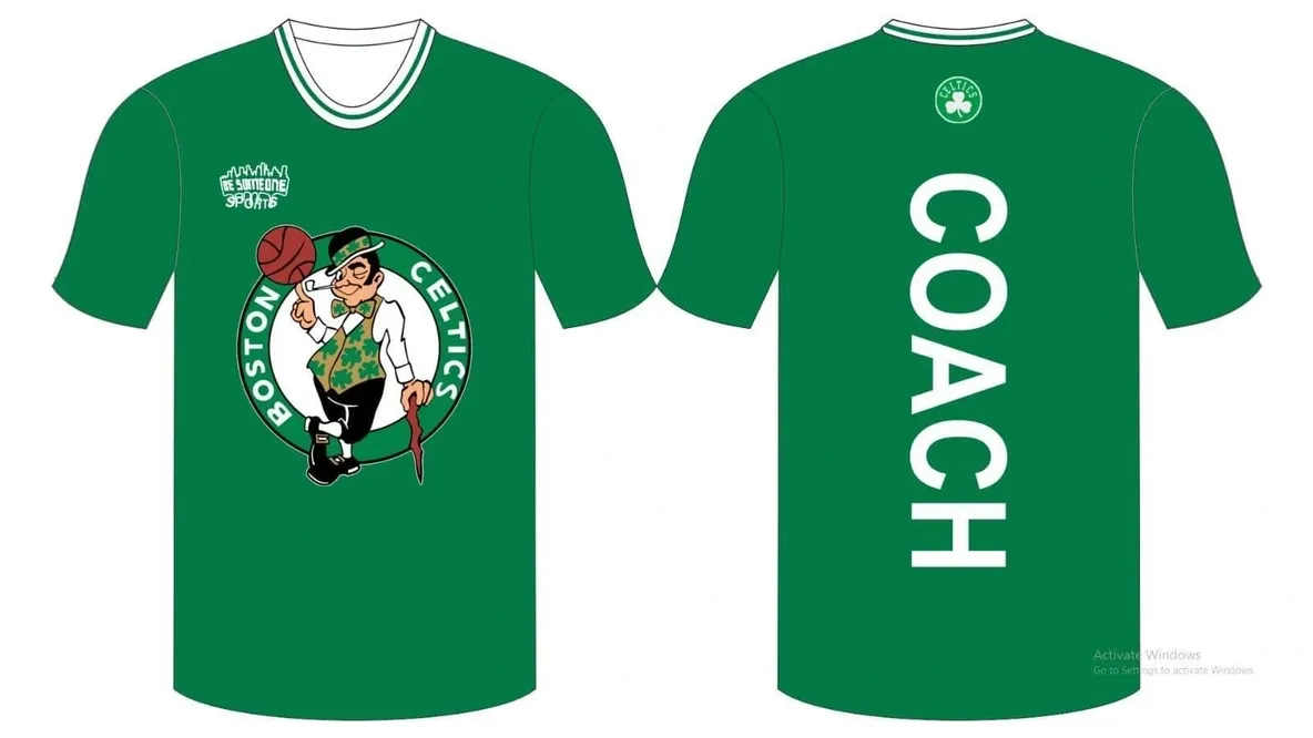 A green shirt with a picture of a person holding a basketball.