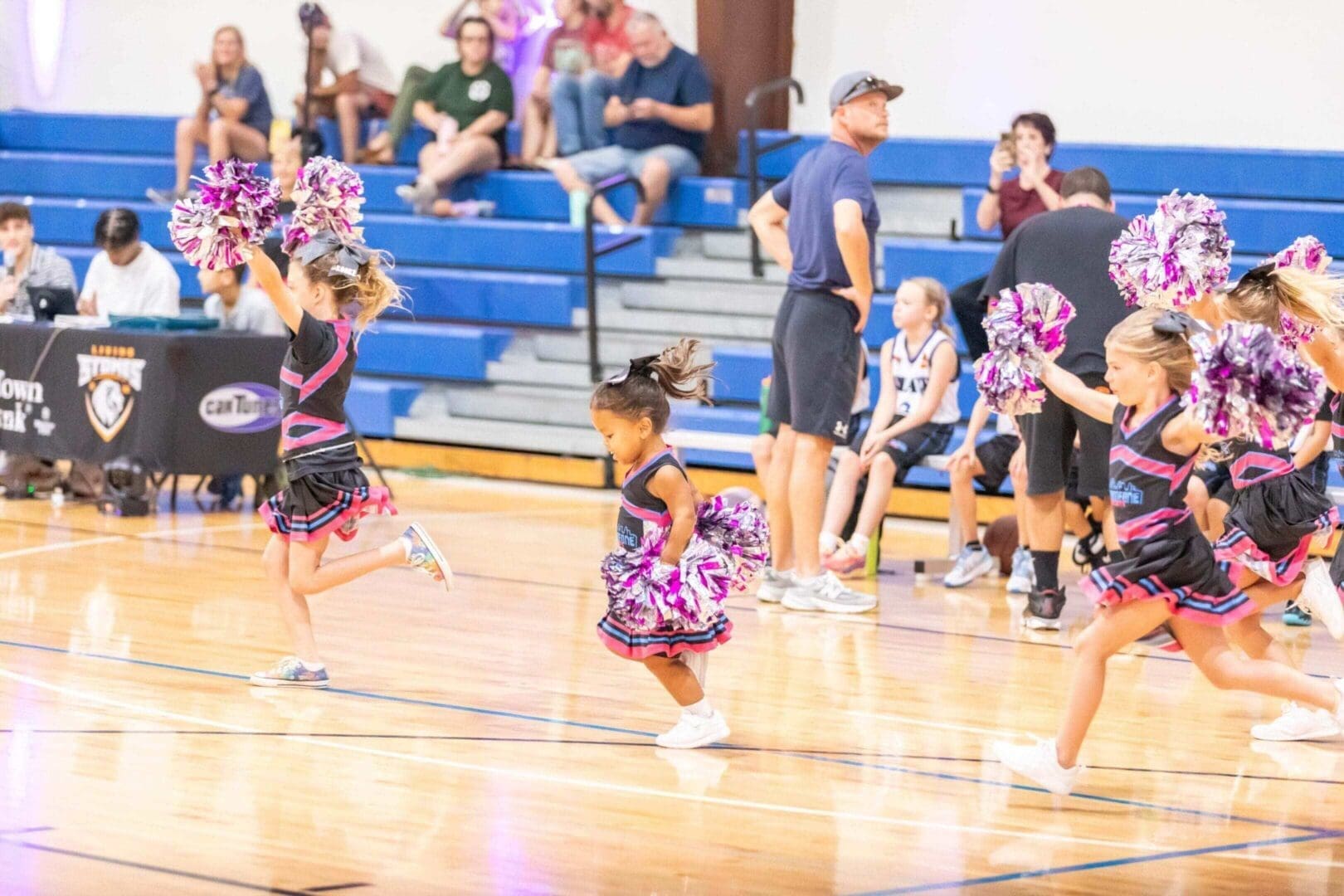 Be Someone cheerleaders performing a routine during a Friendswood competition