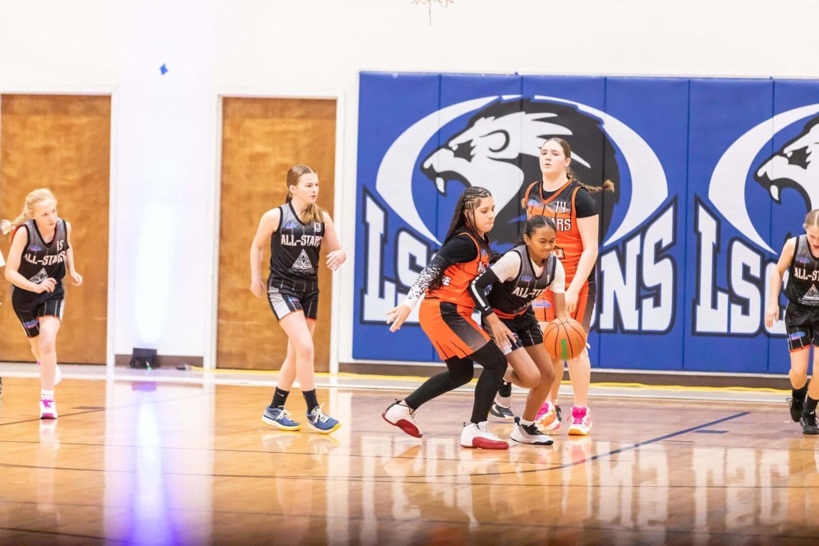 Girls basketball game in action on court