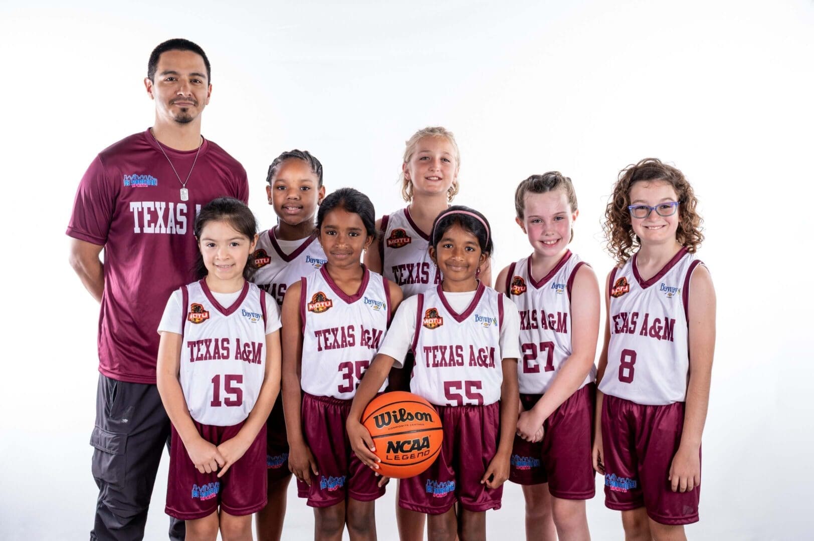 Youth basketball team with coach, group photo.