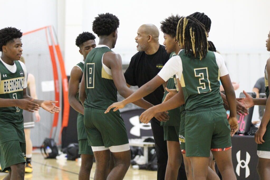 Basketball team huddles during a game.