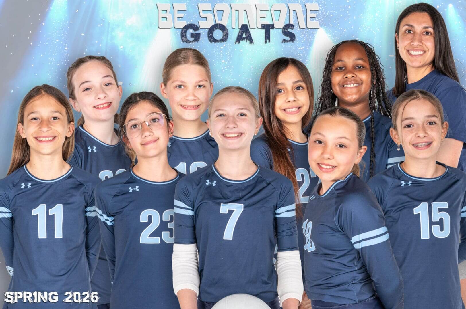 Youth volleyball team posing together, smiling.