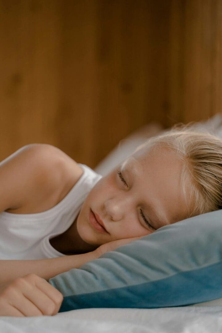 Young child sleeping peacefully — sleep is when athletes rebuild