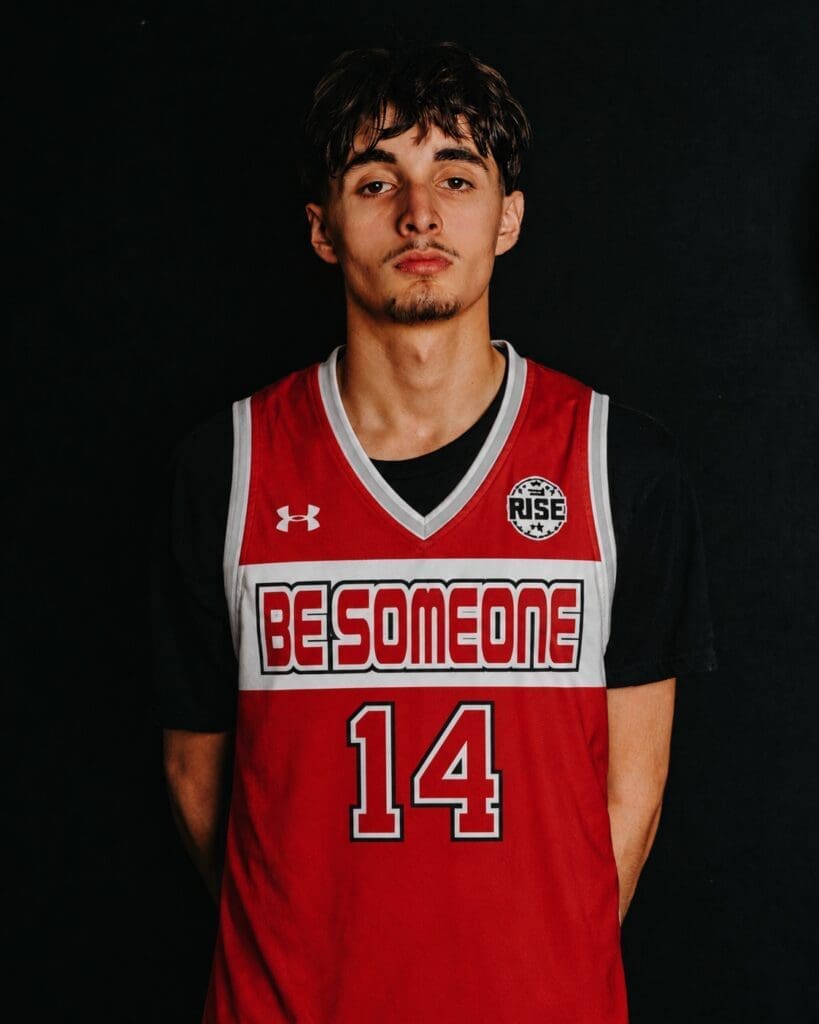 Young basketball player wearing red jersey number 14
