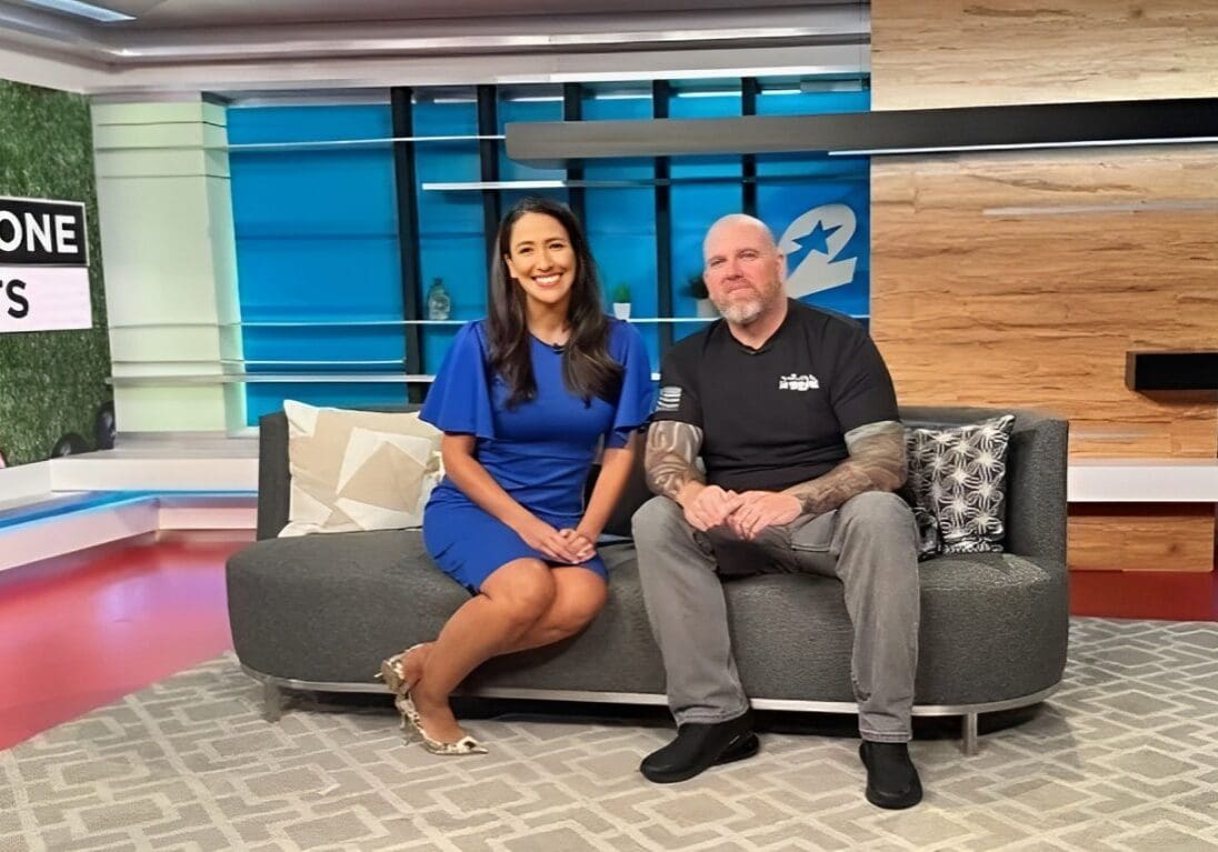 A woman and man sitting on top of a couch.