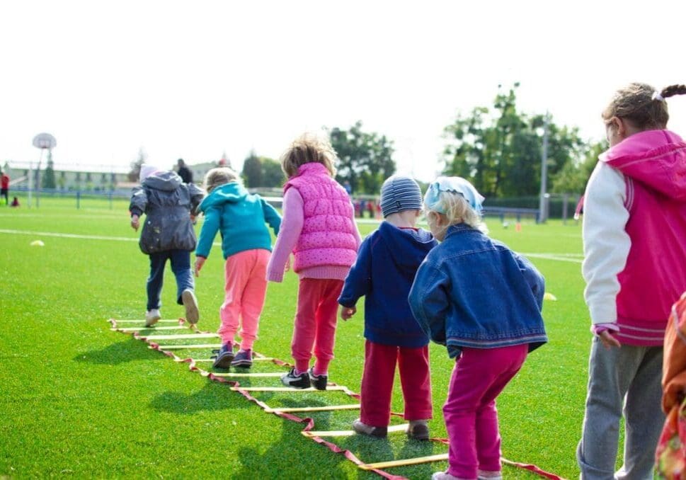 Young athletes performing dynamic warm-up drills before practice
